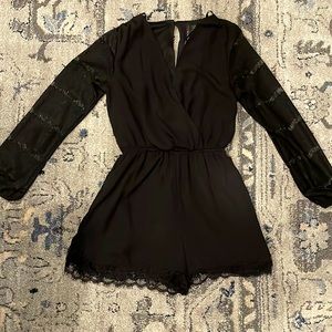 Black short romper with lace sleeves and lace detail